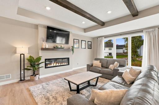 Family Room w/ wood ceiling beams & beautiful custom fireplace