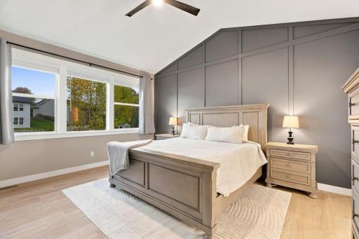 Vaulted Primary Suite w/ luxury Private Bath, floor-to-ceiling tiled shower & oversized WIC w/ direct Laundry Room access