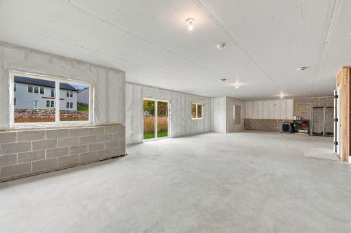 Unfinished walkout Lower Level w/ 9' ceilings, bath rough-in & incredible potential for future living space
