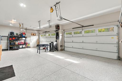 OVERSIZED 4-CAR GARAGEâheated, insulated & finished w/ epoxy flooring, floor drain & service door