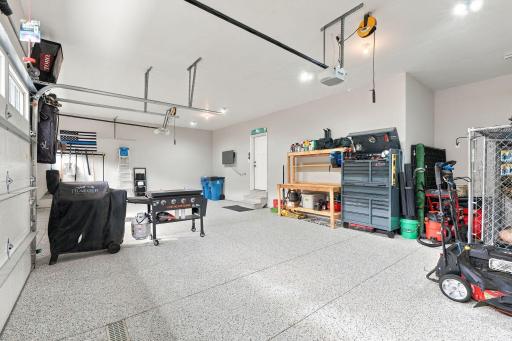OVERSIZED 4-CAR GARAGEâheated, insulated & finished w/ epoxy flooring, floor drain & service door