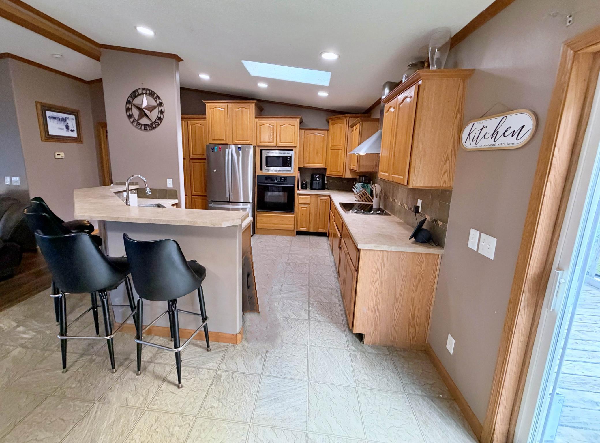 Dining area and Kitchen with slide door to deck.jpg