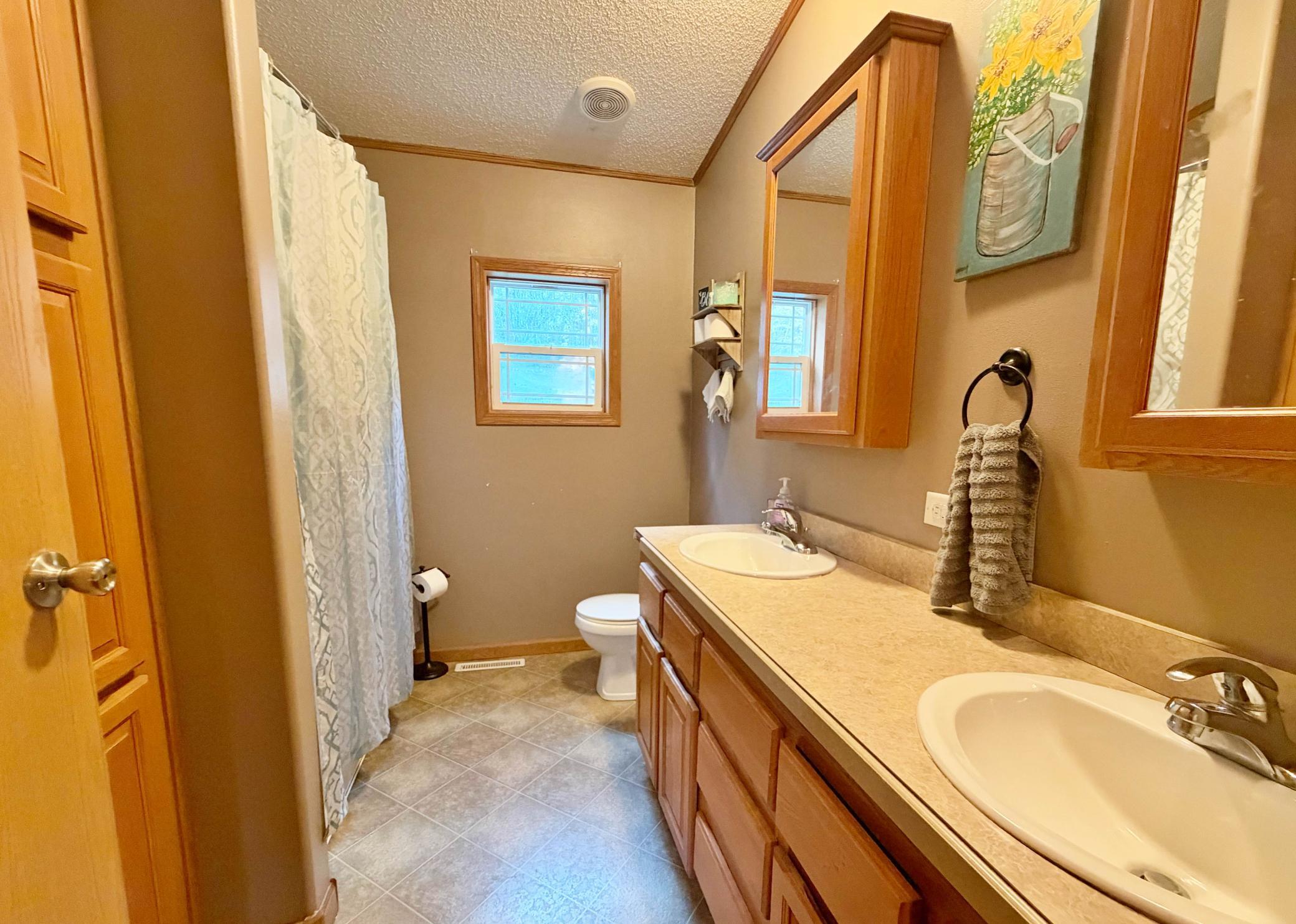 Main level Guest Bath Full with double vality.jpg