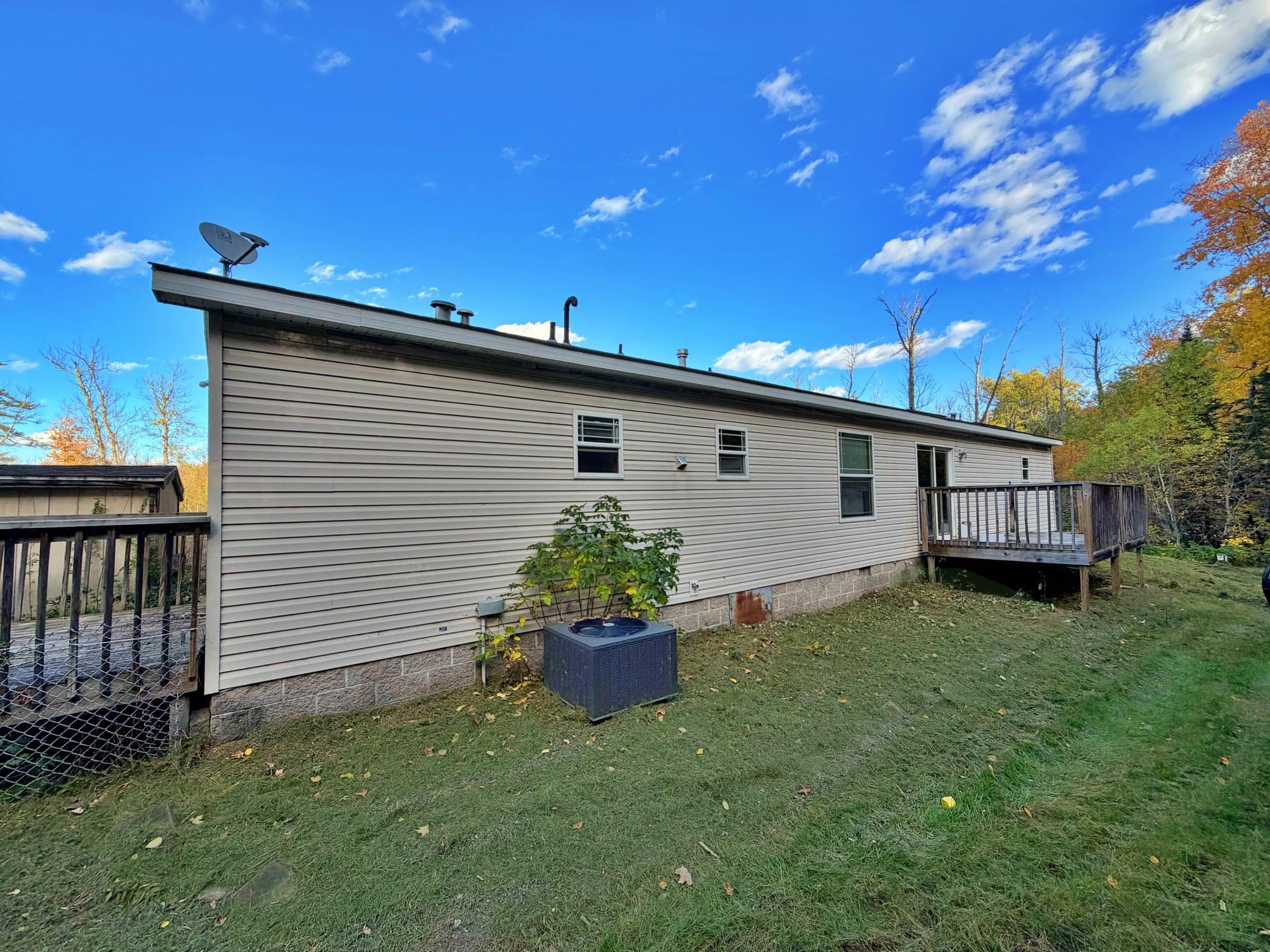 Back yard view of home with back deck
