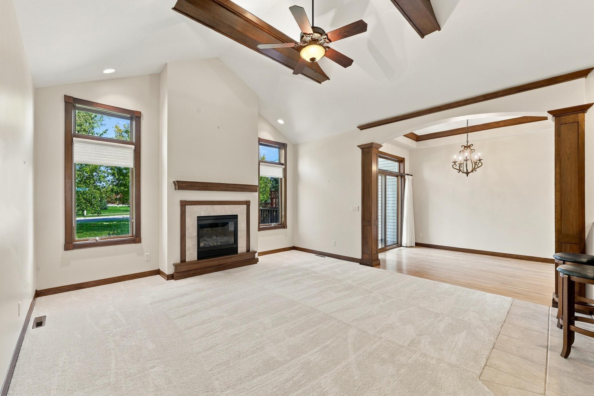 Living Room with deep vaulted ceiling, gas fireplace and dining area