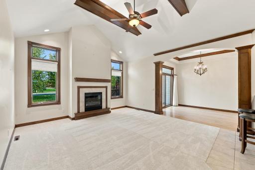 Living Room with deep vaulted ceiling, gas fireplace and dining area
