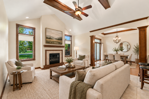 Living Room with deep vaulted ceiling, gas fireplace and dining area - Virtually Staged