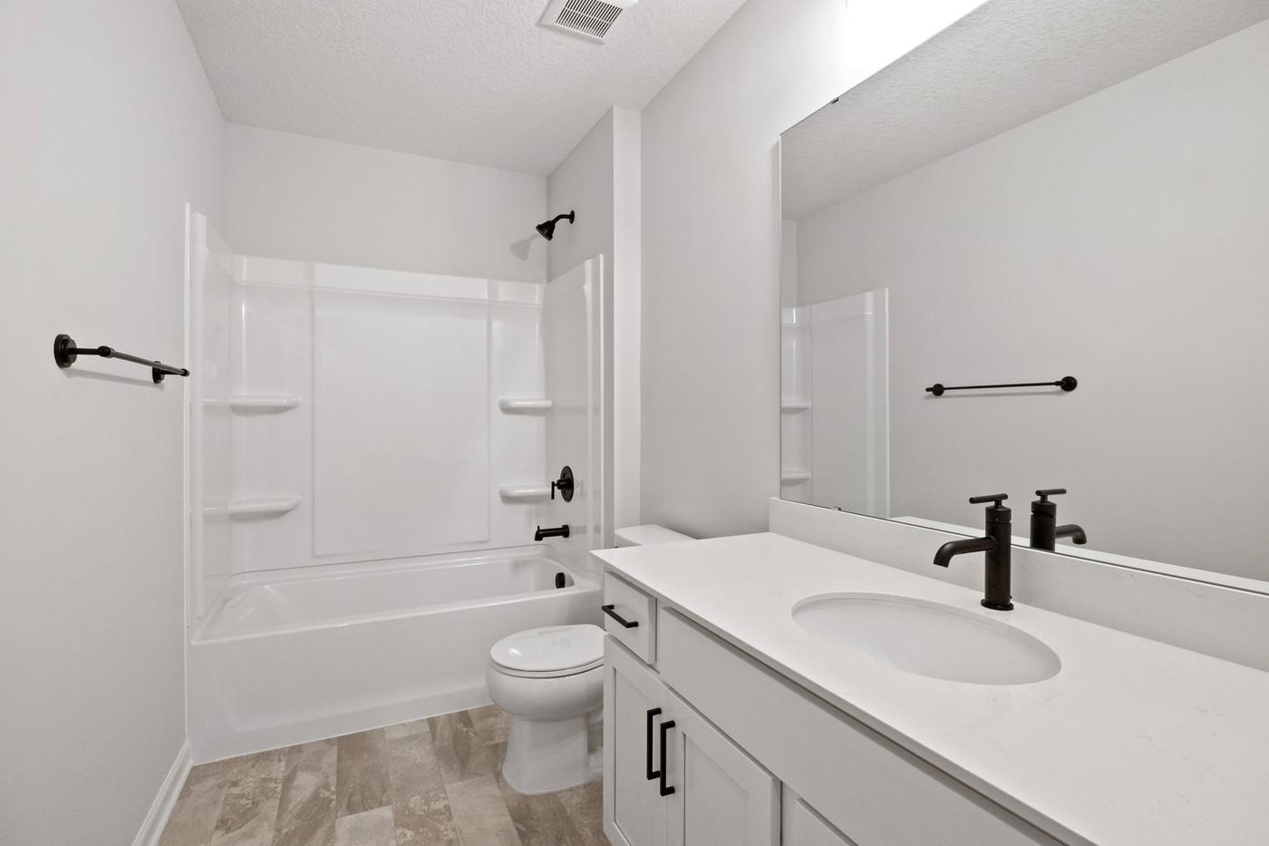Upper level full bath shared by the 3 secondary bedrooms (Photo of a similar home - Colors and selections will vary)