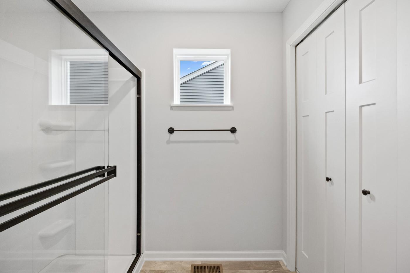 Owner's bathroom shower and large linen closet. (Photo of a similar home - Colors and selections will vary)