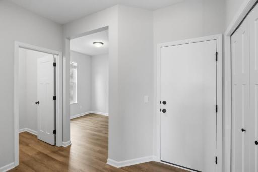 This area is off the garage: spacious mudroom with closet, powder bath, and an office space that's tucked away from the rest of the home. (Photo of a similar home - Colors and selections will vary)