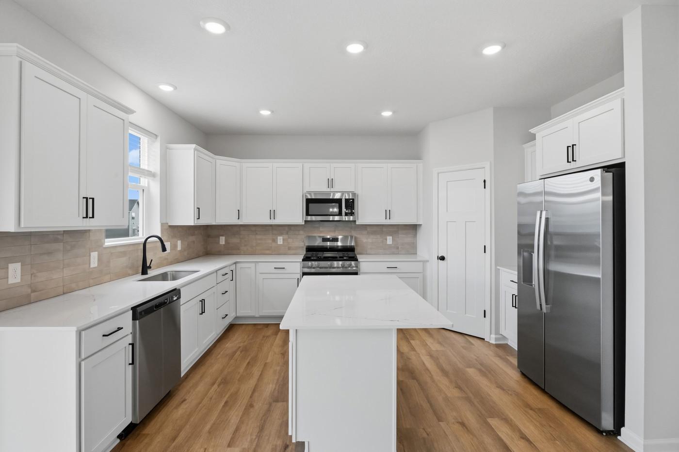 Plenty of cabinet space plus a corner pantry. (Photo of similar home - Colors and selections will vary)
