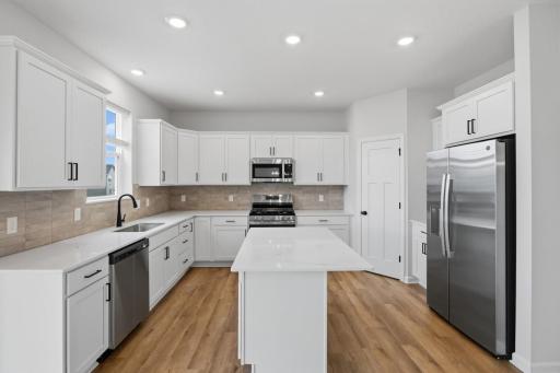 Plenty of cabinet space plus a corner pantry. (Photo of similar home - Colors and selections will vary)