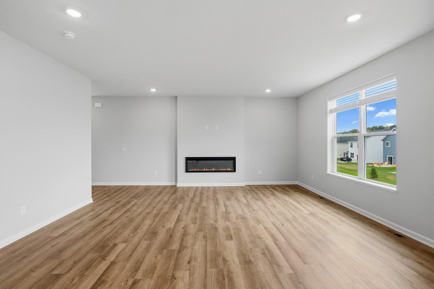 The family room is anchored around a low maintenance electric fireplace that keeps the room feeling very open. Bonus is that you can use the fireplace with or without heat. (Photo of similar home - Colors and selections will vary)