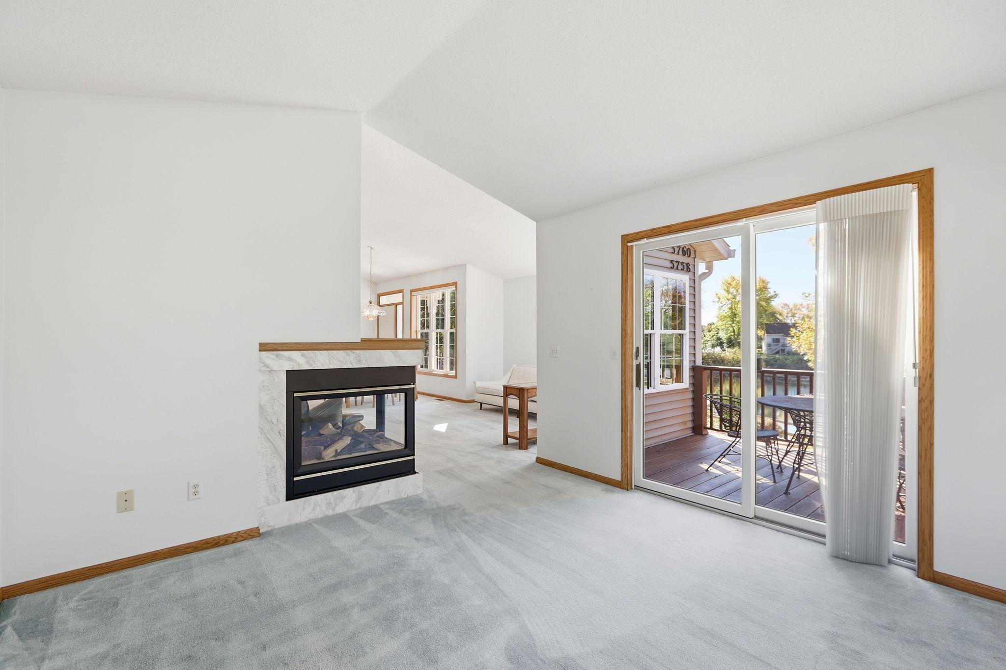 Sunroom has the advantage of the fireplace and walkout to the deck.