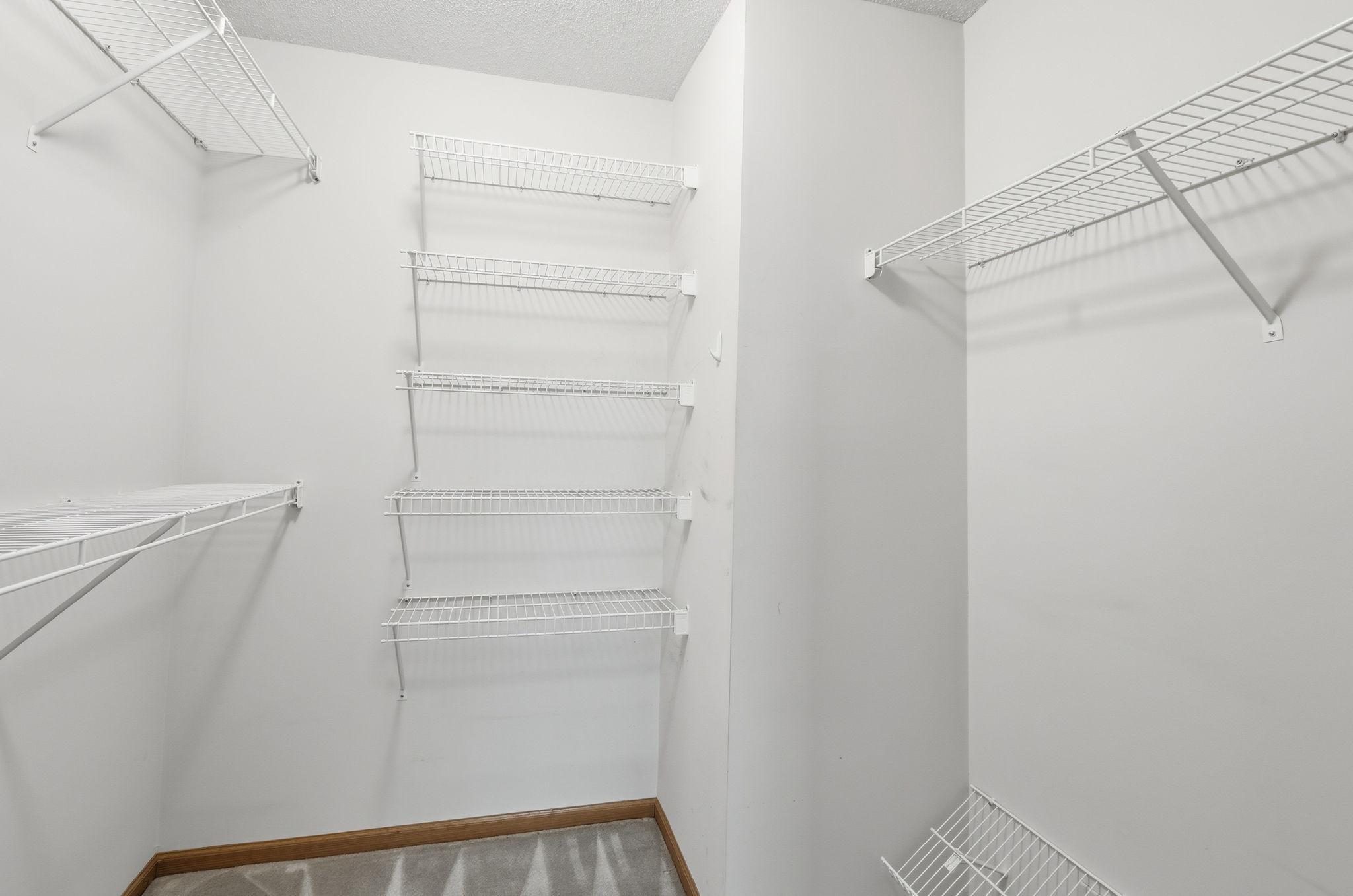 Walk-in closet for primary bedroom.