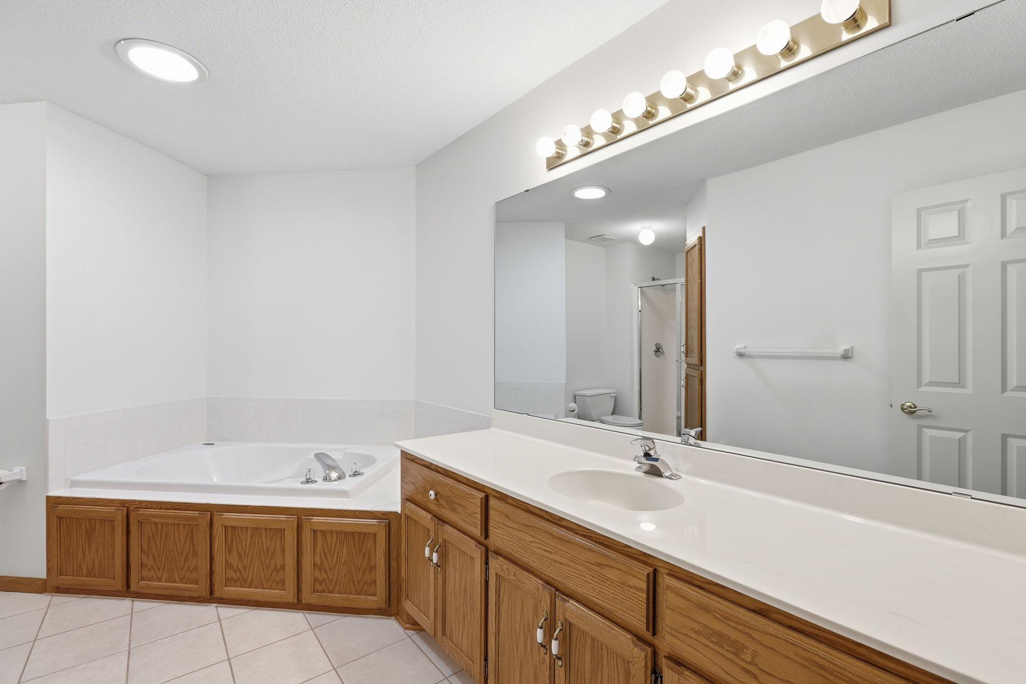Main floor bath has large amount of counter space and deep tub.