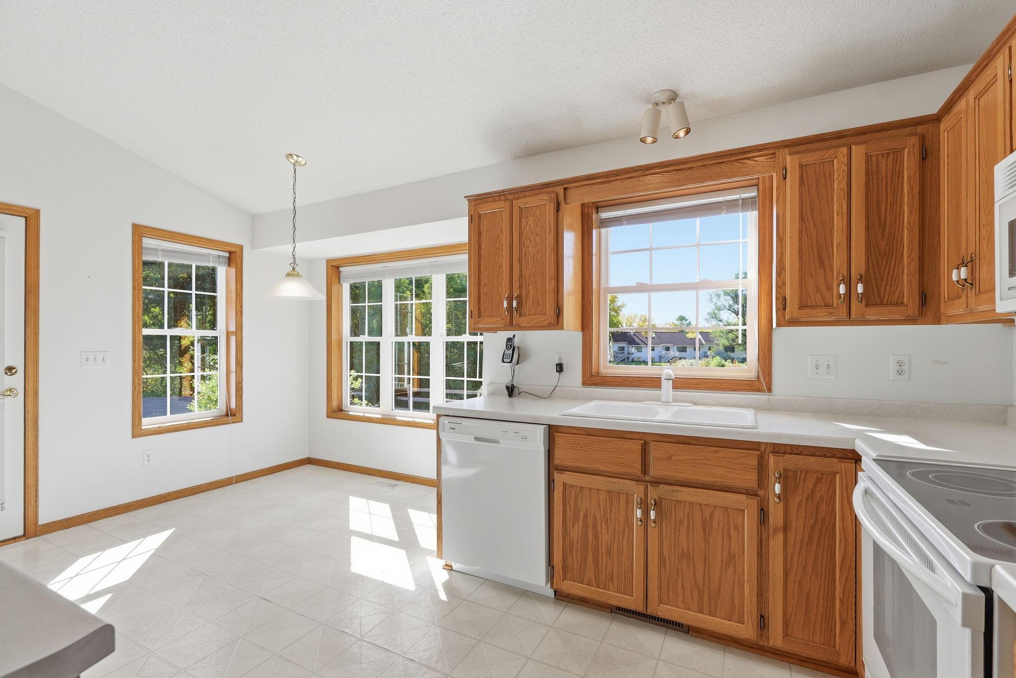 Open Kitchen with views out kitchen sink to the pond.