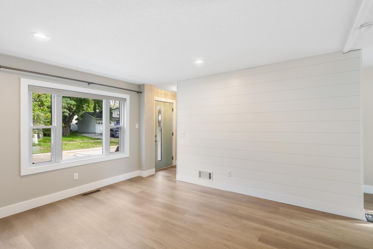 The solid wood shiplap adds a nice historic touch to the home's main floor. An excellent nod to this home's historic past.