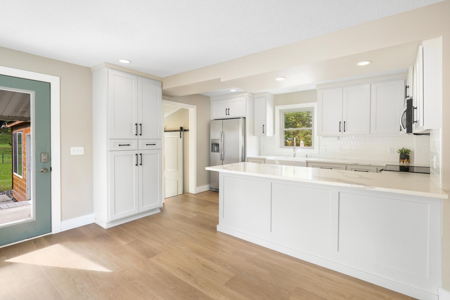 Custom-made cabinetry, quartz countertops, full tile backsplash and stainless steel appliances are the new kitchen's main features.
