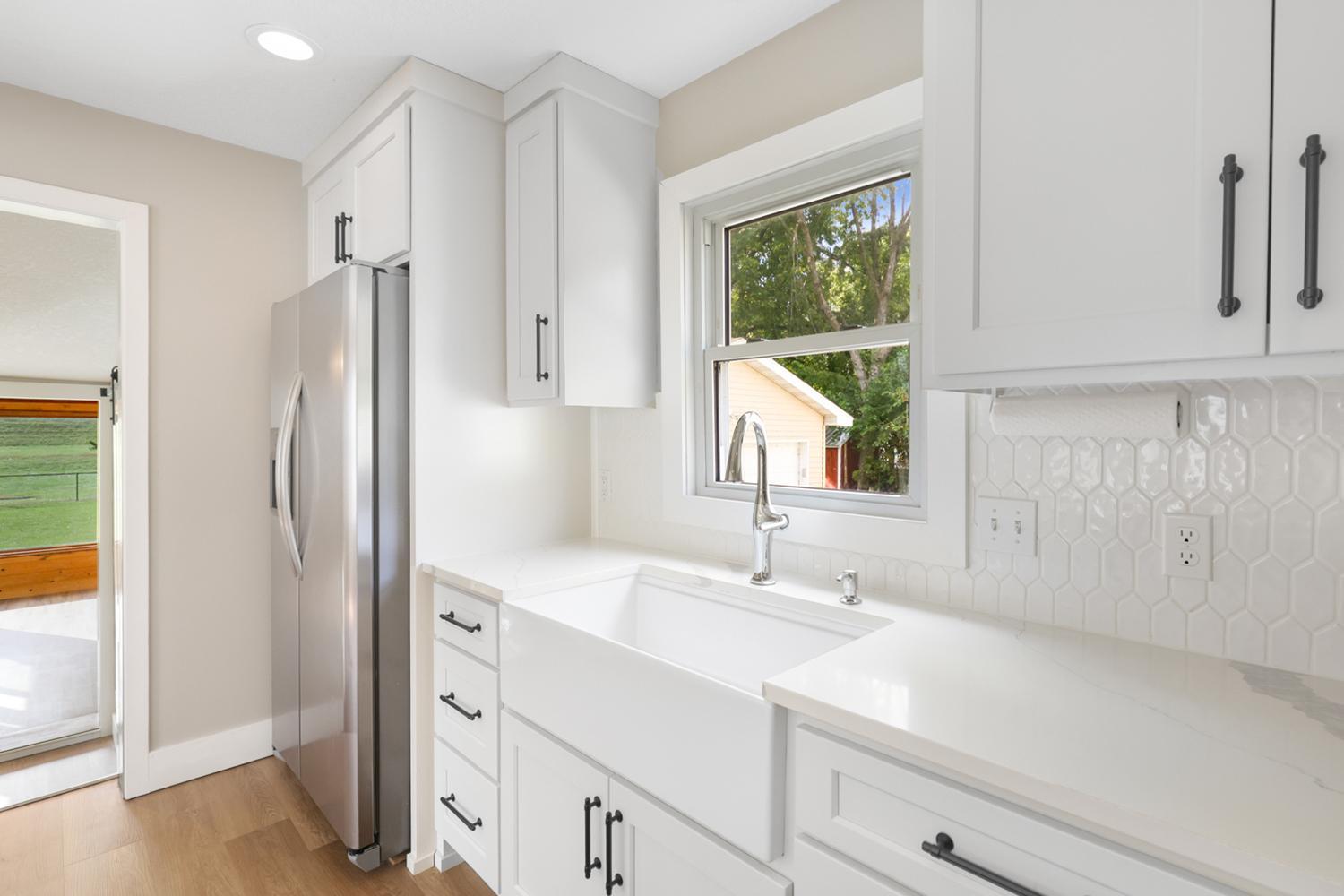 The farm sink and kitchen window add a nice touch to this stylish kitchen.