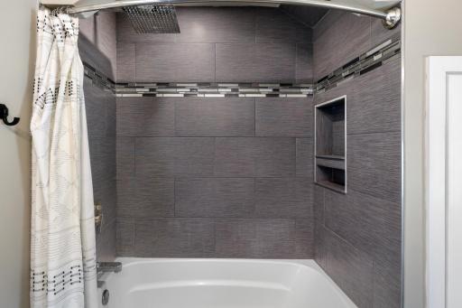Beautiful custom tile accents this fully remodeled bathroom.