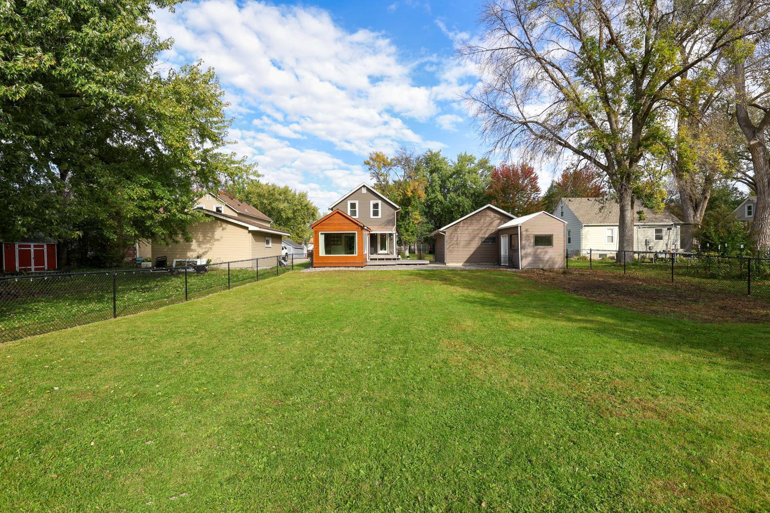 The backyard features a large area with new chain link fencing. Great place for kids and pets to play.