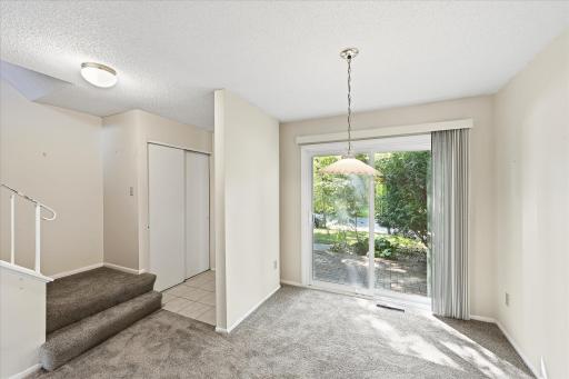 The sliding glass door opens to the front brick patio.