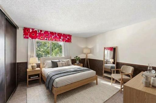 Second bedroom upstairs, facing the pretty trees in the front of the building. (virtually staged)