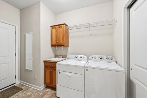 Enjoy the convenience of a spacious laundry room with plenty of room to organize your belongings!
