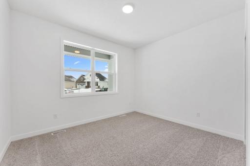 Both secondary bedrooms include a practical closet and premium wall-to-wall carpeting for plush comfort.