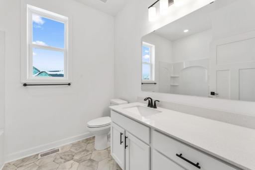 A full-sized bathroom off the foyer is readily accessible to the whole family and daytime guests.