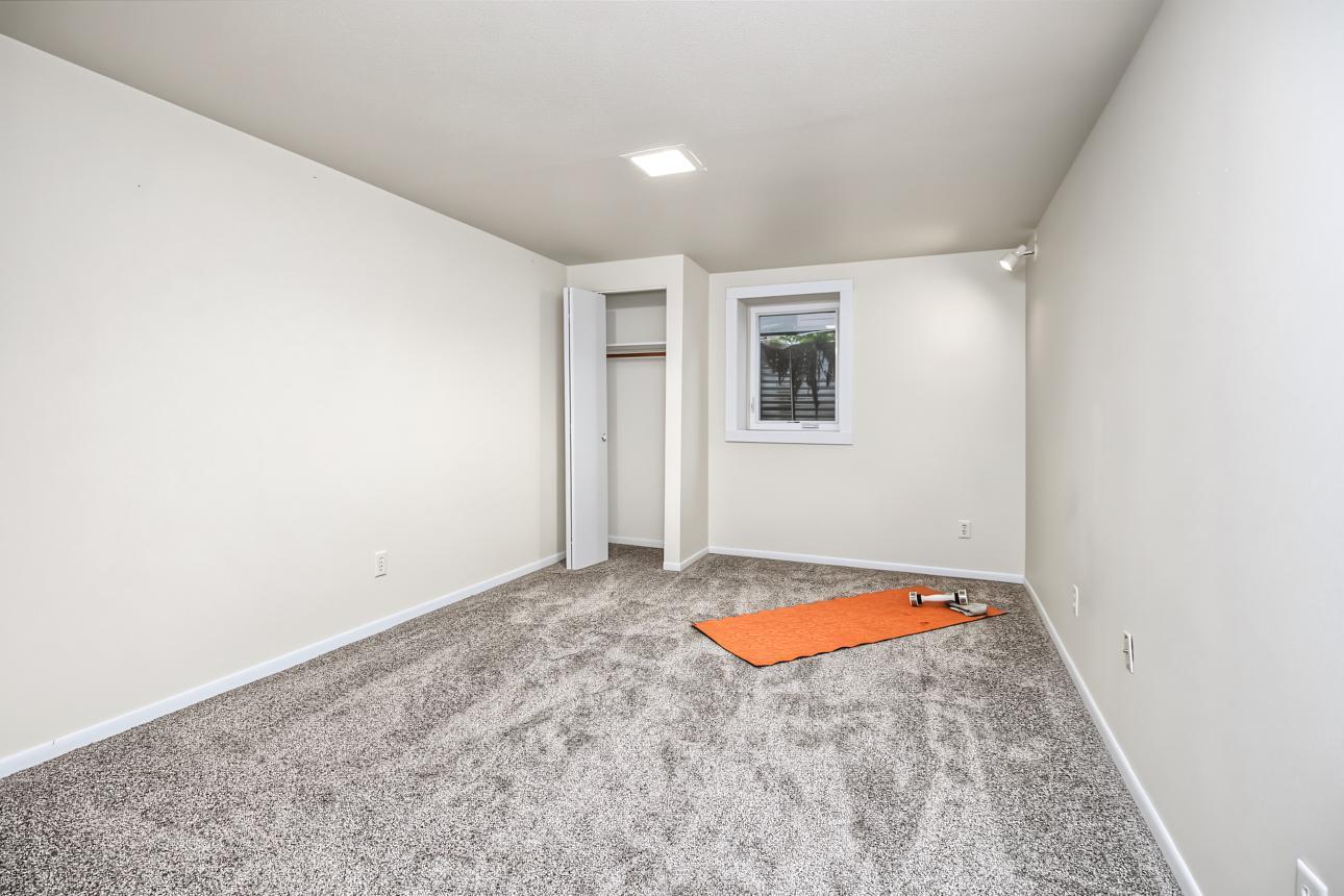 Lower level bedroom with egress window and new carpet 2026.