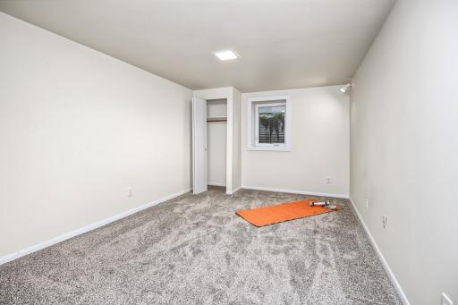 Lower level bedroom with egress window and new carpet 2026.
