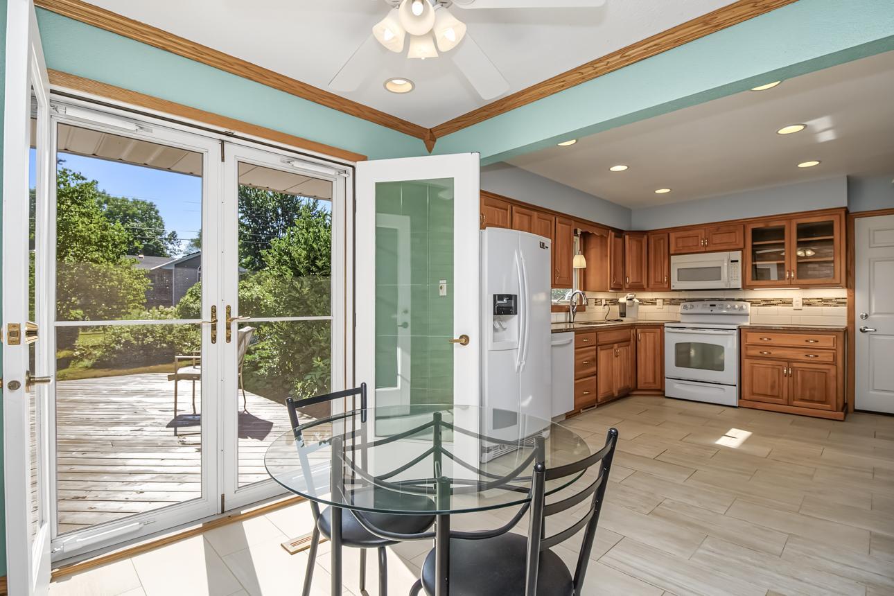 Open french doors to deck and backyard.