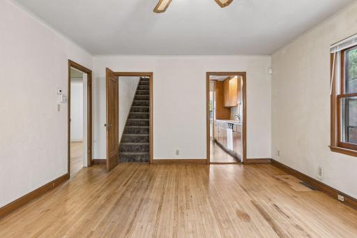 From the living room, head upstairs, into the galley kitchen, or to the two main level bedrooms and bathroom.