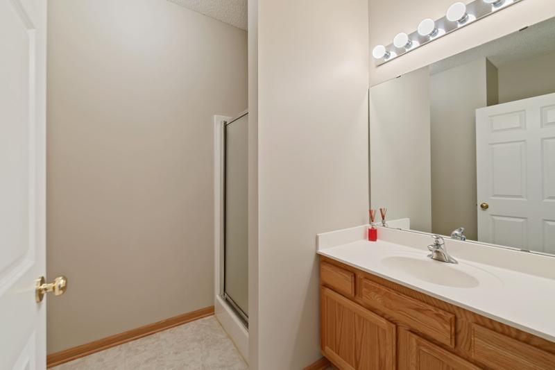 The hallway bath has a shower and plenty of space for guests.