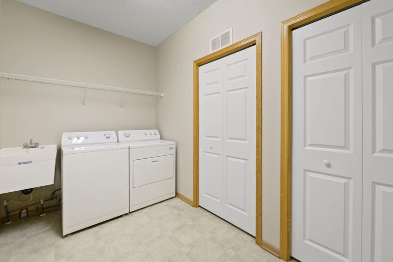 The laundry room has a huge storage closet, room for plenty of shoes and a laundry tub.