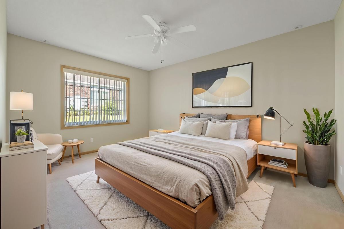 The primary bedroom is near the back of the townhouse, away from the road. (Photo virtually staged)