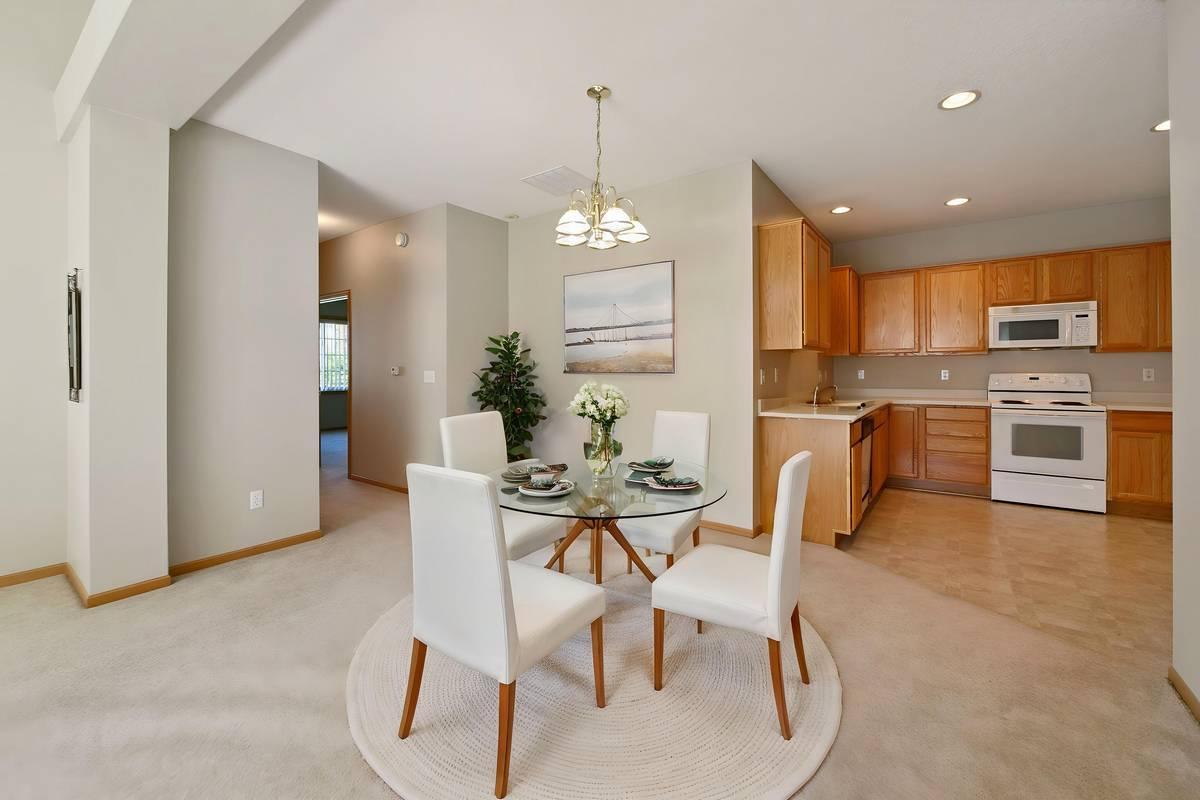 The open floorplan has room for a dining room AND eat-in kitchen! Or, removed the dining room light and you'll have a wonderfully big living room! (Photo virtually staged)