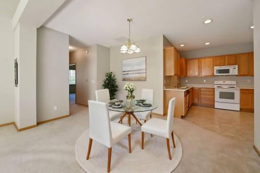 The open floorplan has room for a dining room AND eat-in kitchen! Or, removed the dining room light and you'll have a wonderfully big living room! (Photo virtually staged)
