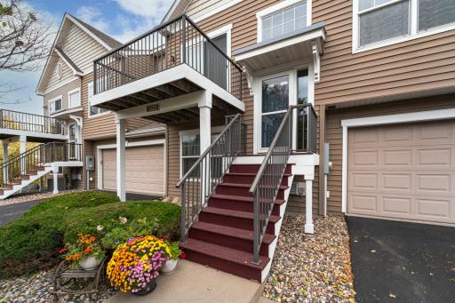 The front entrance is neat and clean, and is landscaped with attractive black railings with white trim.