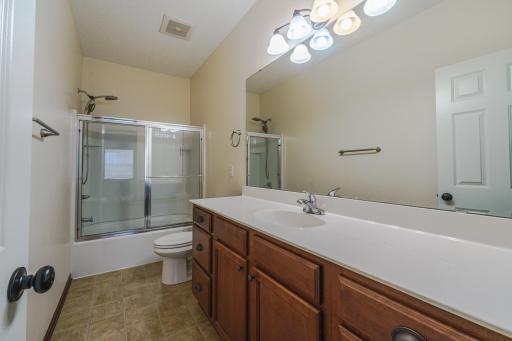 The FULL bathroom has a huge vanity top and lots of cabinetry.