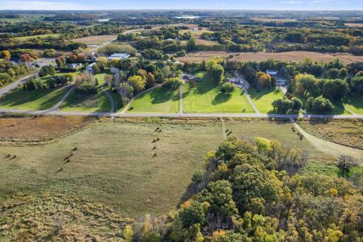 Looking east -- existing homes on acreage parcels across the road, new homes going up on this side of the road.