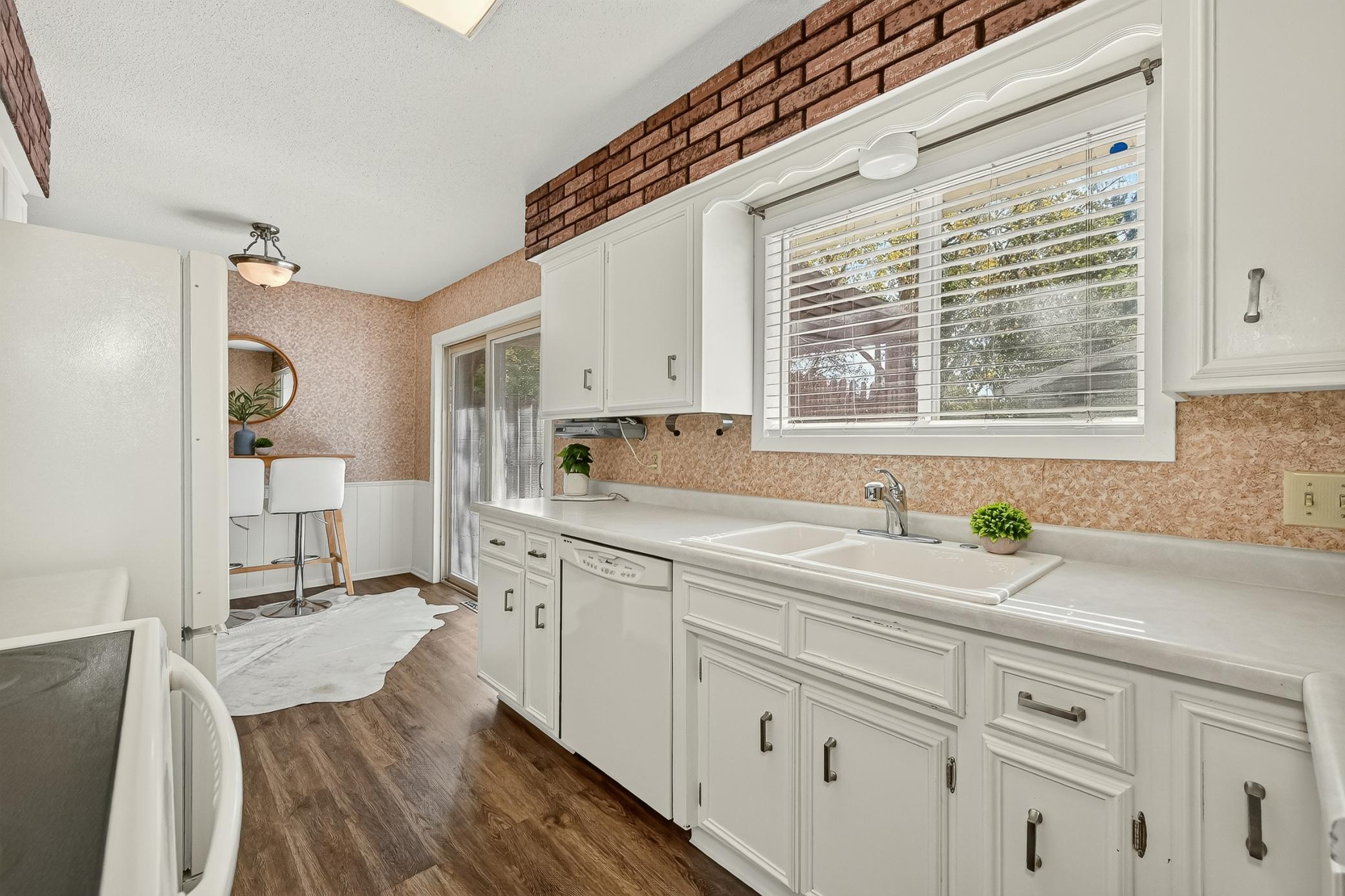 Large kitchen window over looks backyard.