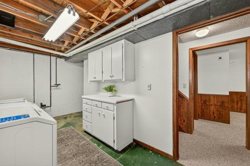 With access directly at the bottom of the stairs, the laundry room also provides plenty of additional storage space behind the wall.