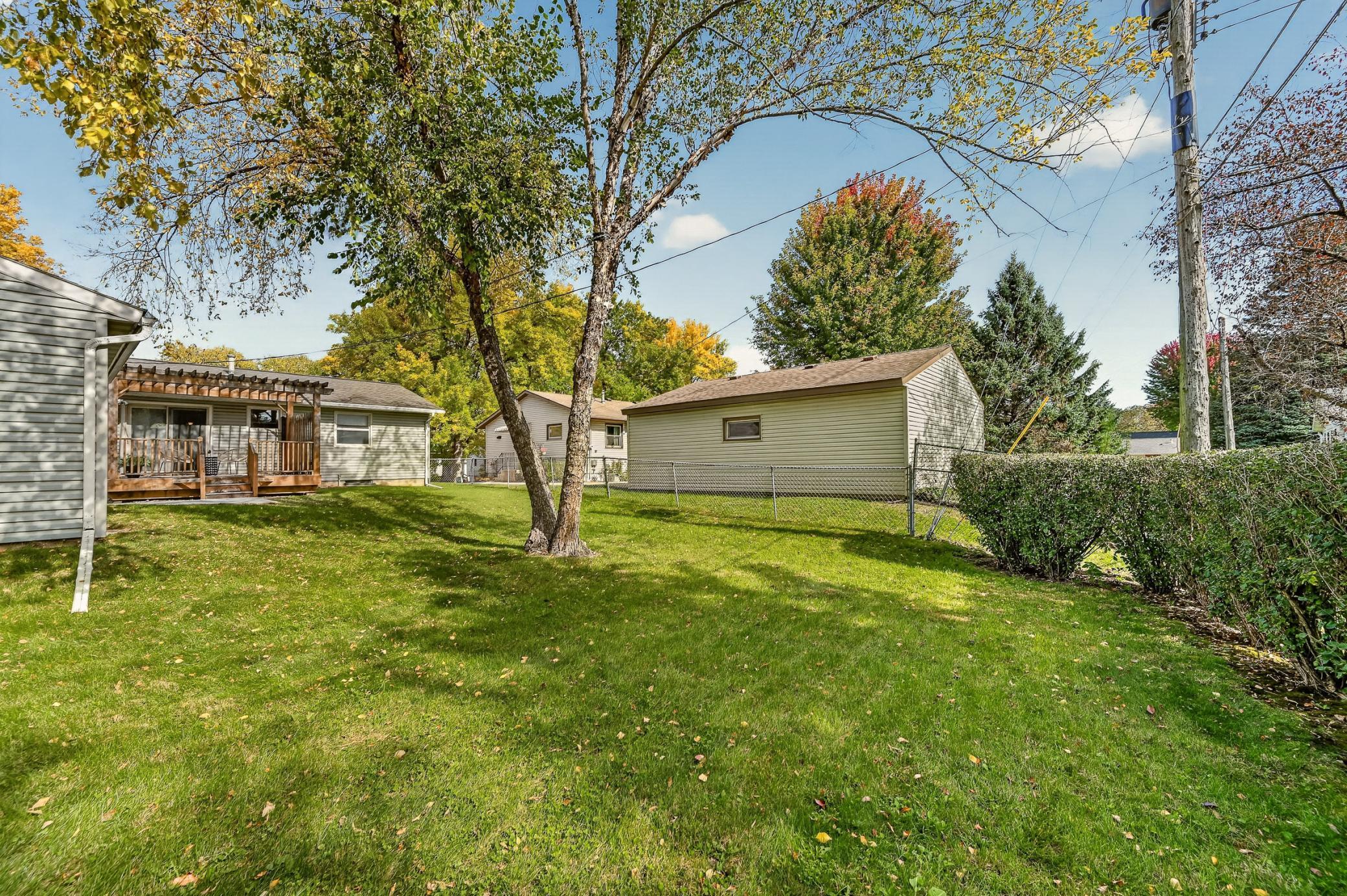 Enjoy the spacious backyard with mature trees and established shrubs that create a wonderful sense of privacy, with the added benefit of an almost fully fenced yard.