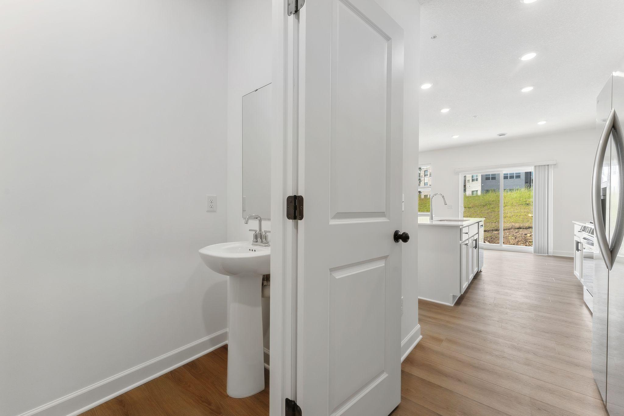 Situated directly off the kitchen, this powder room optimizes the first-floor main living area for residents and guests alike.