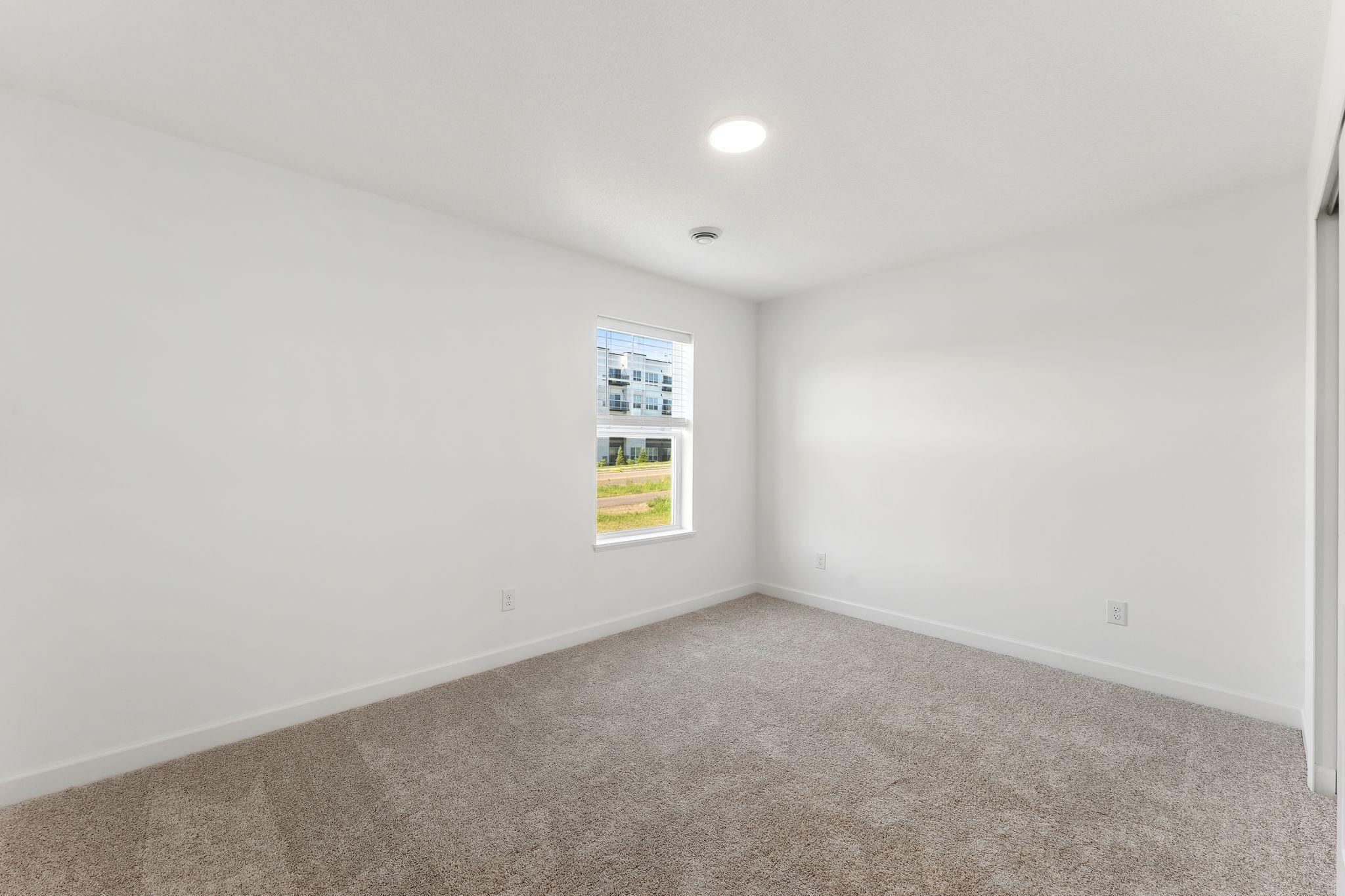 The upper-level secondary bedrooms are perfectly situated away from the downstairs main living areas and are blank canvases ready to be personalized. Furnished here as a cozy nursery.