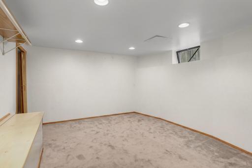 The lower-level flex room features built-in storage plus a closet, and if you add an egress window, voila, you have a fourth bedroom.