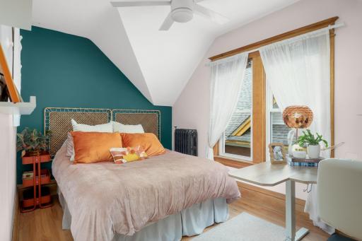Bedroom 2 on the upper level is so charming with the angles and beautiful natural light.